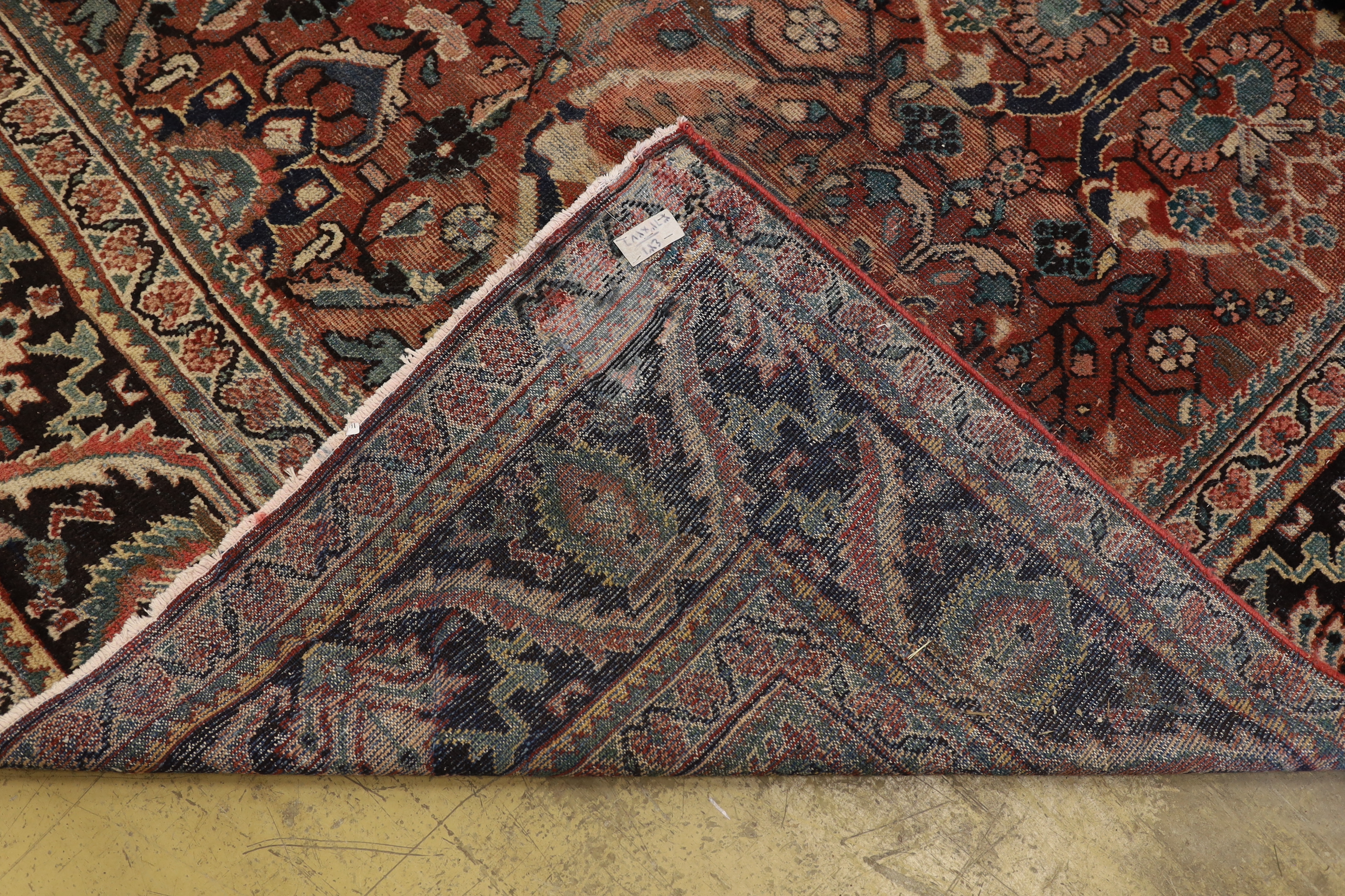 A Heriz brick red ground carpet, 370 x 280cm